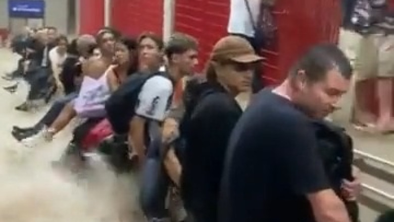 Surreal Flood Escape: Commuters Take Shelter on Railings as Tube Station Submerges!